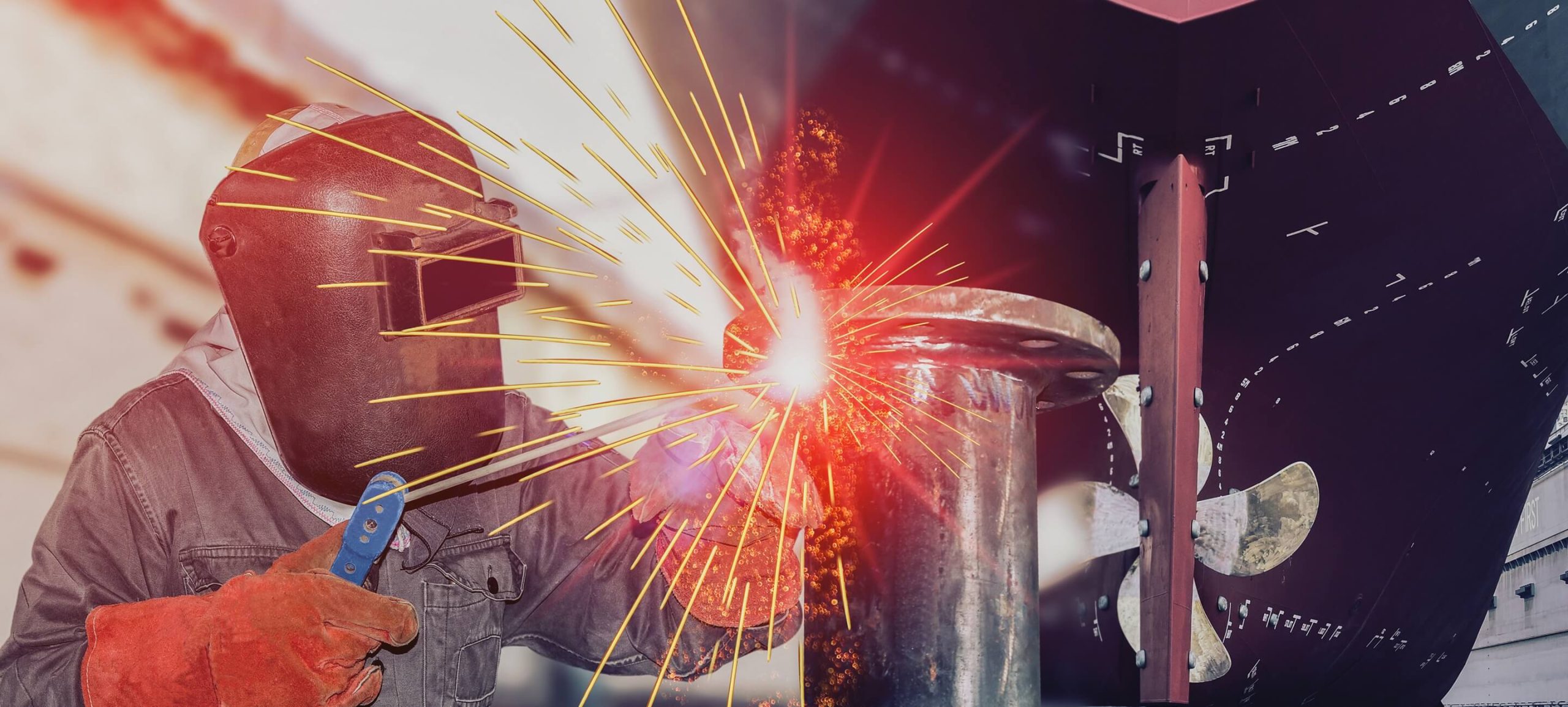 Welder in a protective mask creating bright orange sparks while performing arc welding on a metal pipe in an industrial setting.